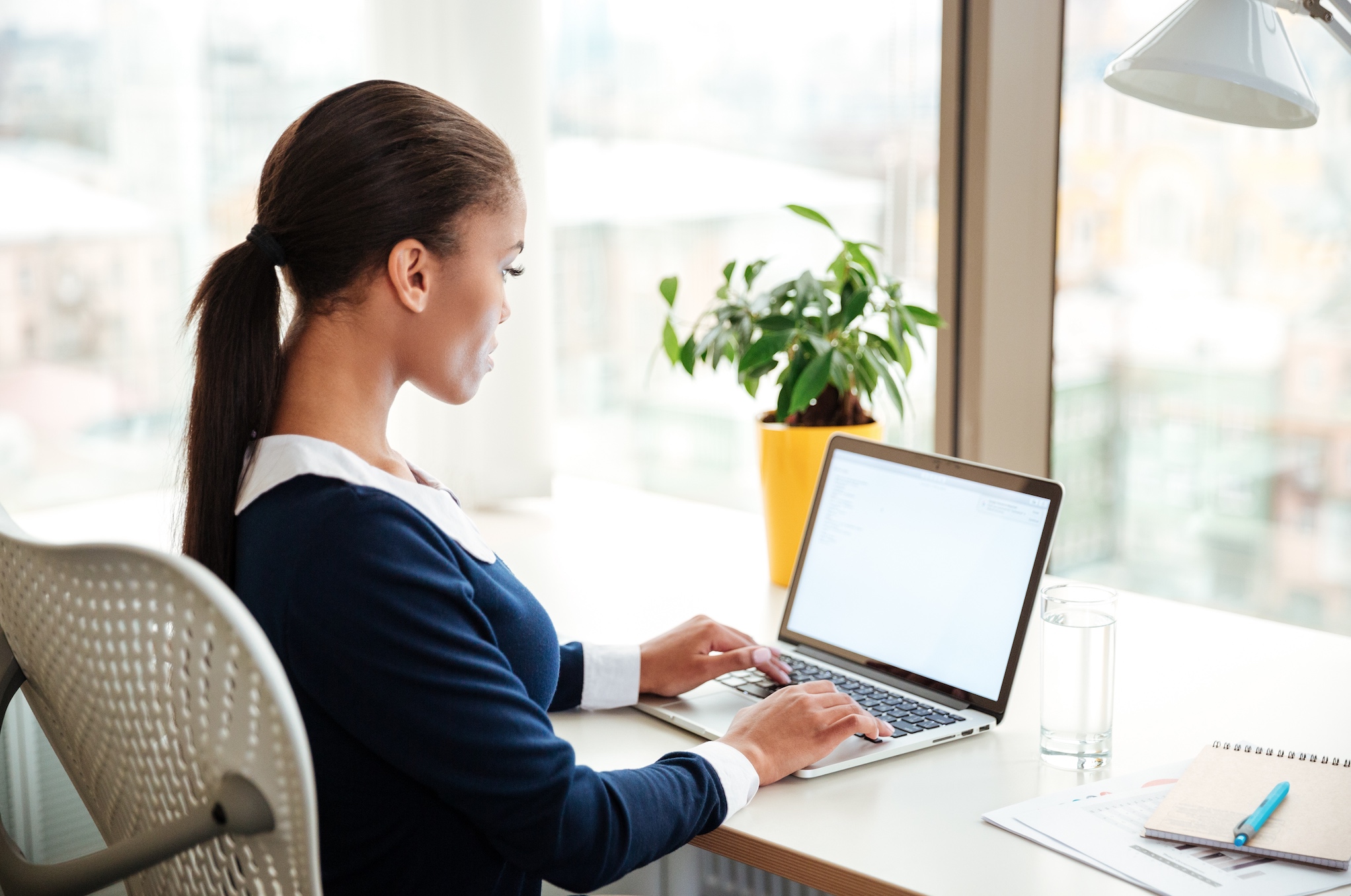 "TEFL trainee studying on a laptop"